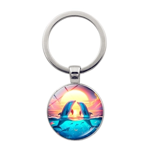 Artistic dolphin pendant keychain featuring dolphins leaping at sunset in silver metal