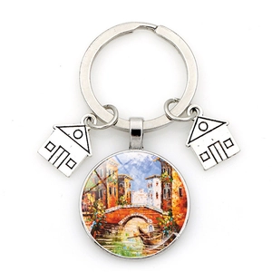Detailed view of Venice oil painting charm with small silver house pendants on keychain