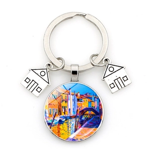 Detailed view of Venice oil painting keychain with miniature silver house charms