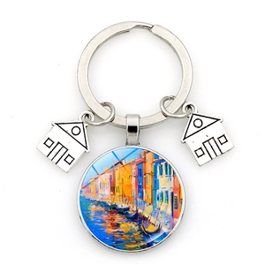 Close-up of Venice landscape keychain with silver house charms and glass art pendant