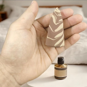 Detailed view of dual-tone marble textured makeup sponge being held by a hand