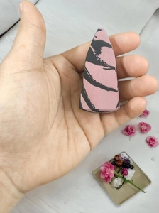 Close-up of pink and black marble makeup sponge with fine pores for seamless blending