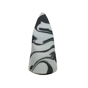 Detailed macro view of dual-color marble pattern makeup sponge with soft cone-shaped texture