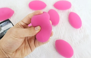 Macro shot showing the soft texture and high resilience of the pink makeup sponge