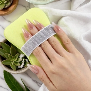 Macro detail of soft light green exfoliating sponge with silver glitter hand strap