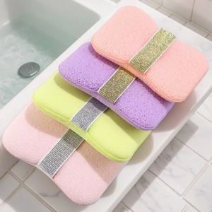 Detail showing four colorful honeycomb bath sponges with glitter straps in a sink setup
