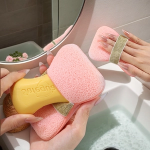 Pink exfoliating bath sponge with gold elastic strap and rich lather for body cleaning