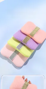 Macro detail of soft honeycomb bath sponges in macaron colors with elastic grip straps