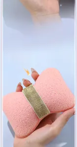 Pink cheese-shaped bath ball with dual-layer mesh and gold glitter ribbon detail