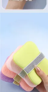Macro detail of soft bath sponge with fine pores and glitter strap for easy grip