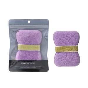 Macro view of purple makeup sponge with elastic band and its branded retail packaging