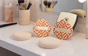 Details von vier Rubycell Make-up Quasten in Orange und Beige mit Haltebändern