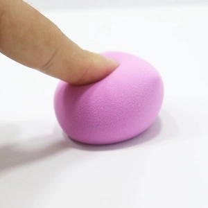 Close-up of soft pink teardrop beauty sponge showing high elasticity and fine texture