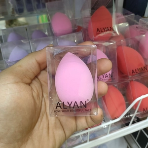 Close-up of soft teardrop makeup sponge in clear individual packaging by ALYAN brand