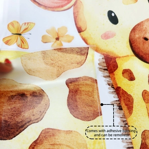 Detail of self-adhesive cartoon giraffe wall sticker being peeled from its paper backing