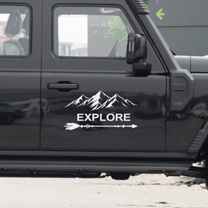 Close-up of white mountain explore vinyl decal applied to a black SUV car door