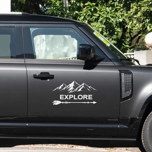 White EXPLORE mountain and arrow vinyl decal on a black off-road vehicle door