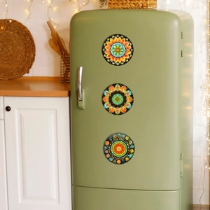 Set of three round mandala patterned magnetic fridge stickers on a vintage refrigerator