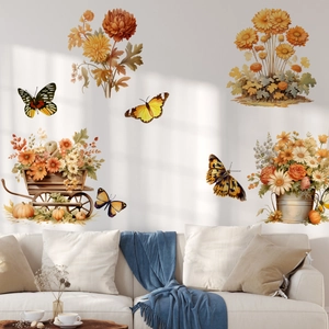 Detail of autumn flower wall stickers with pumpkins and butterflies on a white living room wall