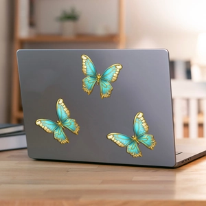 Blue and gold butterfly magnetic decals shown on a laptop lid with metallic finish