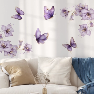 Detail of watercolor purple butterfly and floral wall stickers on a white living room wall