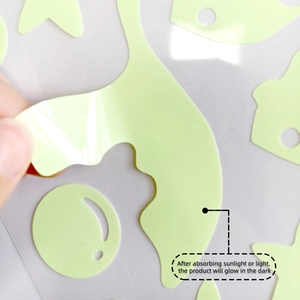 Close-up of peeling luminous mermaid star wall stickers showing adhesive backing and texture