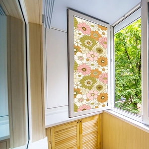 Detailed view of floral window privacy film with colorful daisy patterns on balcony glass
