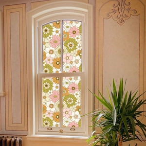 Retro floral window film with 70s daisy pattern applied on a white classic glass window