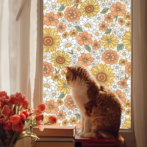Retro sunflower glass film detail featuring 70s orange daisy patterns on a cozy window