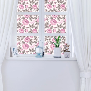 Detail of pink rose and butterfly static cling window film on white window frame