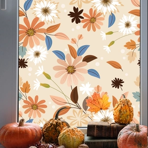 Detail of frosted floral window film with daisies and autumn leaves on glass