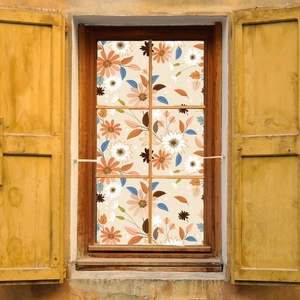 Close-up of elegant floral window film with orange dahlias and blue leaves on a vintage frame