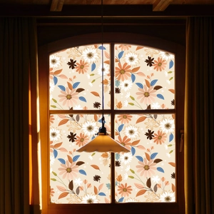 Close-up of vintage daisy floral window film with orange and blue botanical patterns