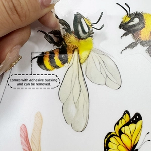 Detail showing the easy peel adhesive backing on transparent bee and butterfly wall stickers
