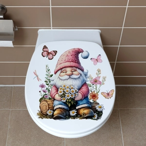 Close-up of cute cartoon gnome and floral stickers on a white toilet lid in a cozy bathroom