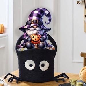 Detail of Halloween spider gift basket featuring a gnome holding a pumpkin for garden decor