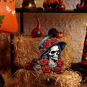 Halloween skeleton garden stake with blue hat and red roses in festive autumn scenery