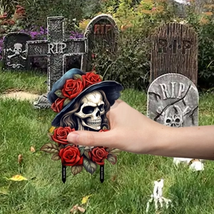 Detail of gothic skull garden stake with red rose hat for Halloween outdoor decoration
