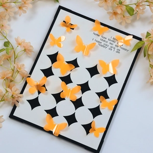 Detailed view of orange 3D butterfly wall stickers with foldable wings on decor board