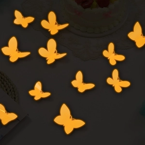 Detailed view of warm orange glowing LED 3D butterflies for party and wall decoration