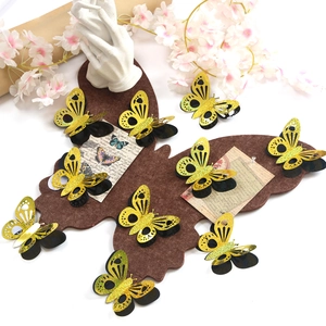 Detail of 3D gold butterfly wall decals with double-layer hollow design and felt board