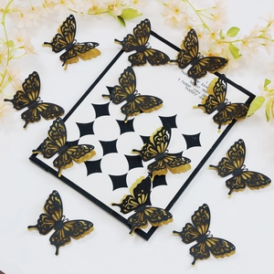 Detail of 3D layered butterflies with black cutout design and golden glitter finish