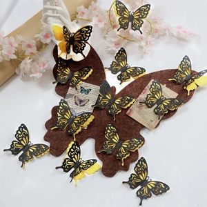 Detailed arrangement of 3D gold hollow butterflies on brown felt board with floral accents