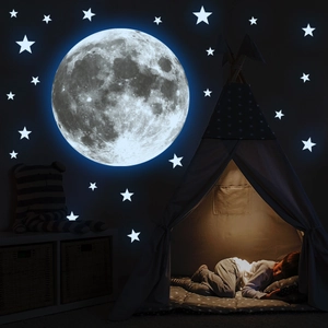 Luminous moon and star wall stickers showing realistic texture and blue glow in kids room