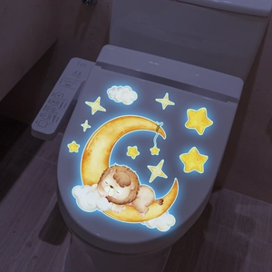 Luminous toilet lid sticker featuring a cute cartoon sleeping lion on a crescent moon