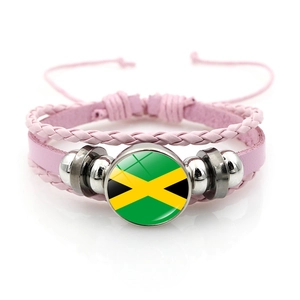 Detail of pink woven leather bracelet with Jamaica flag glass cabochon charm