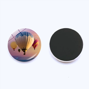 Macro shot of 25mm glass fridge magnet showing hot air balloon design and magnetic back