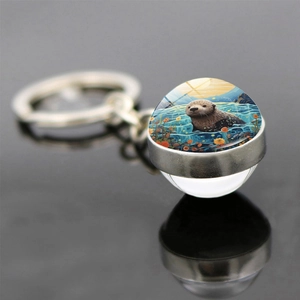 Porte-clés artistique avec pendentif loutre de mer double face et anneau argenté poli