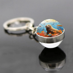 Porte-clés boule de verre lion de mer et fleurs avec anneau métallique poli