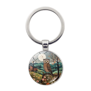 Detailed view of an owl glass gem pendant keychain with vintage artistic moon and forest art